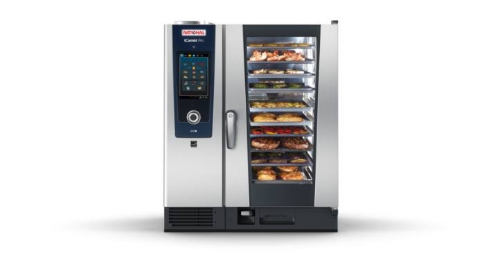 Front view of RATIONAL iCombi Pro combi oven loaded with assorted food trays.